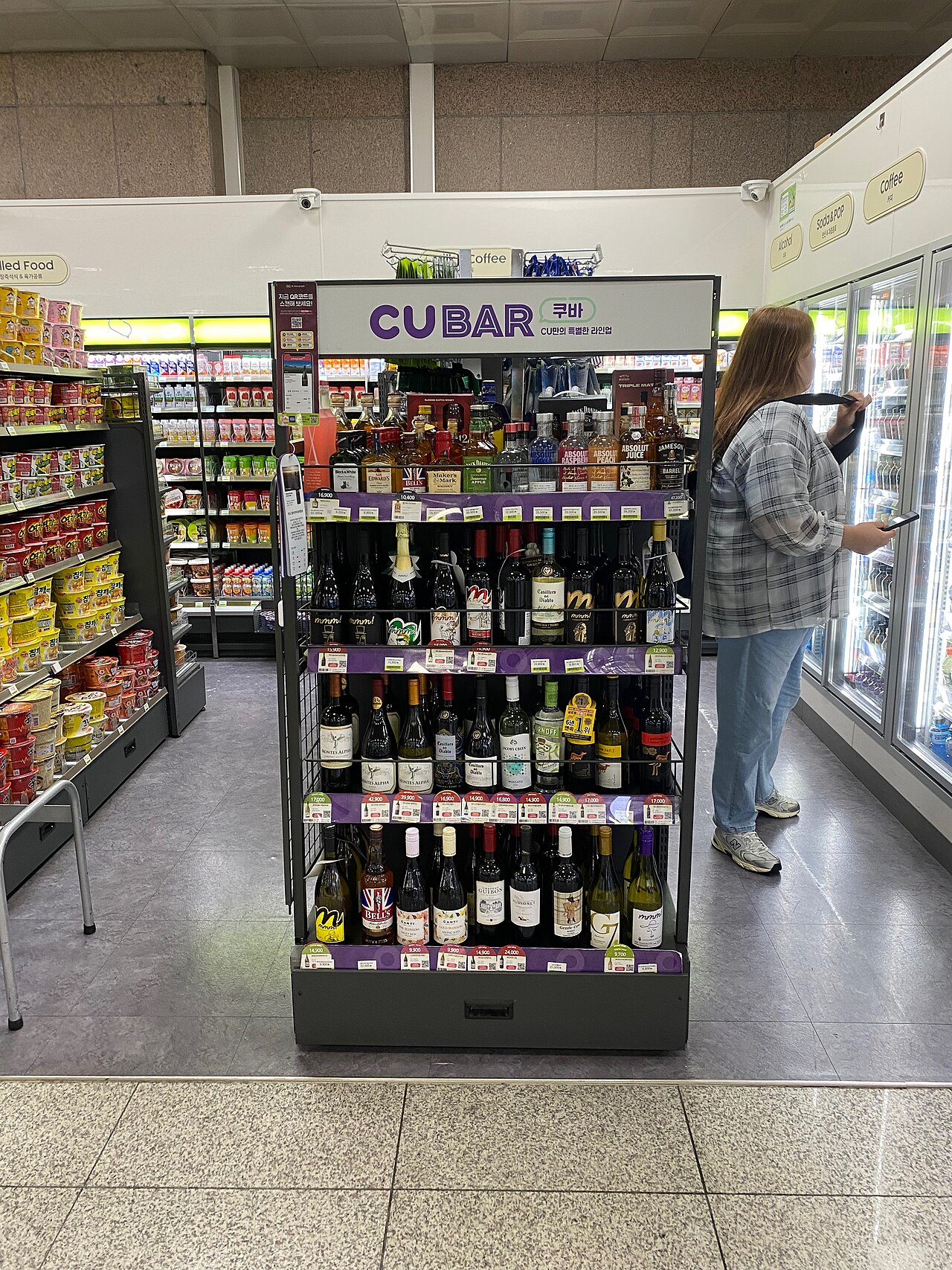 Beer and soju shelves inside a Korean convenience store