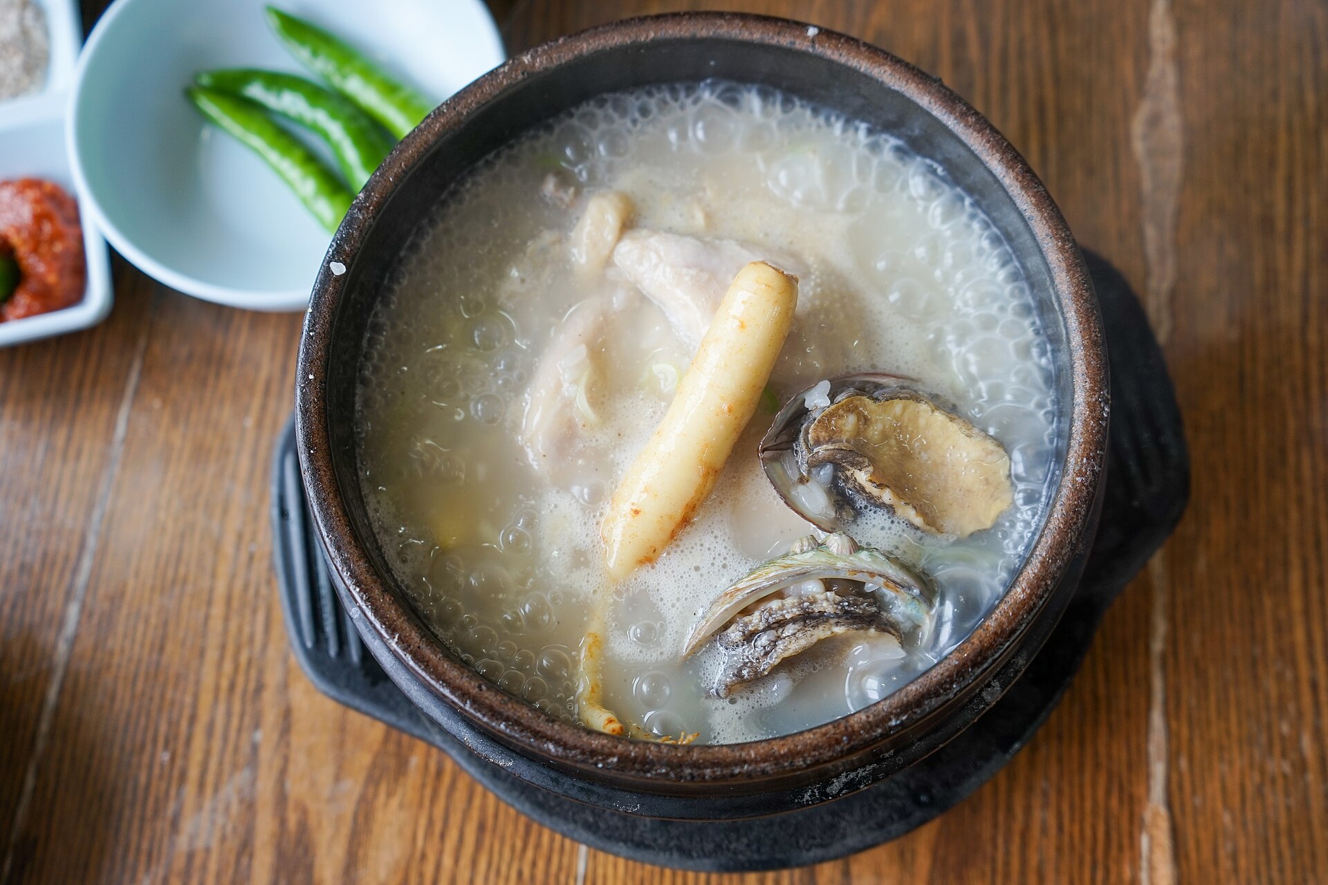 Abalone samgyetang (jeonbok samgyetang) with ginseng in an earthenware pot