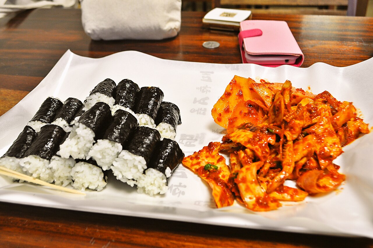 Chungmu kimbap: plain rice-only rolls served with spicy squid and radish kimchi