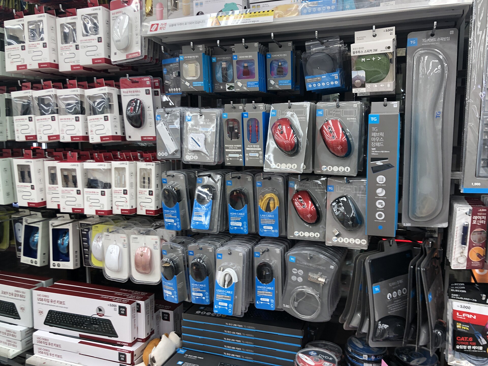 Daiso Korea electronics aisle with cables, adapters and mice priced at 3,000 and 5,000 won