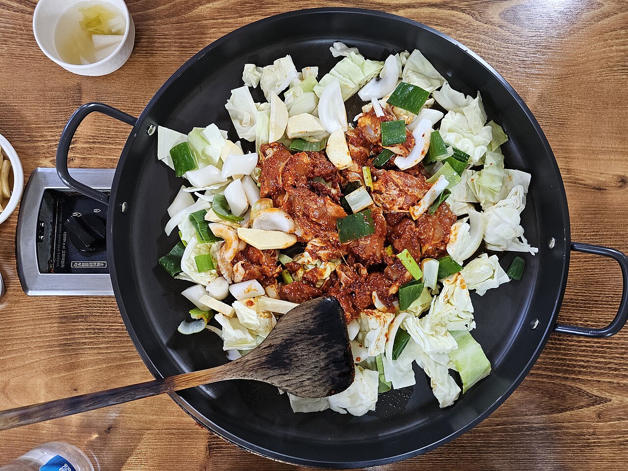 Raw marinated chicken, cabbage, sweet potato and rice cakes ready for dakgalbi