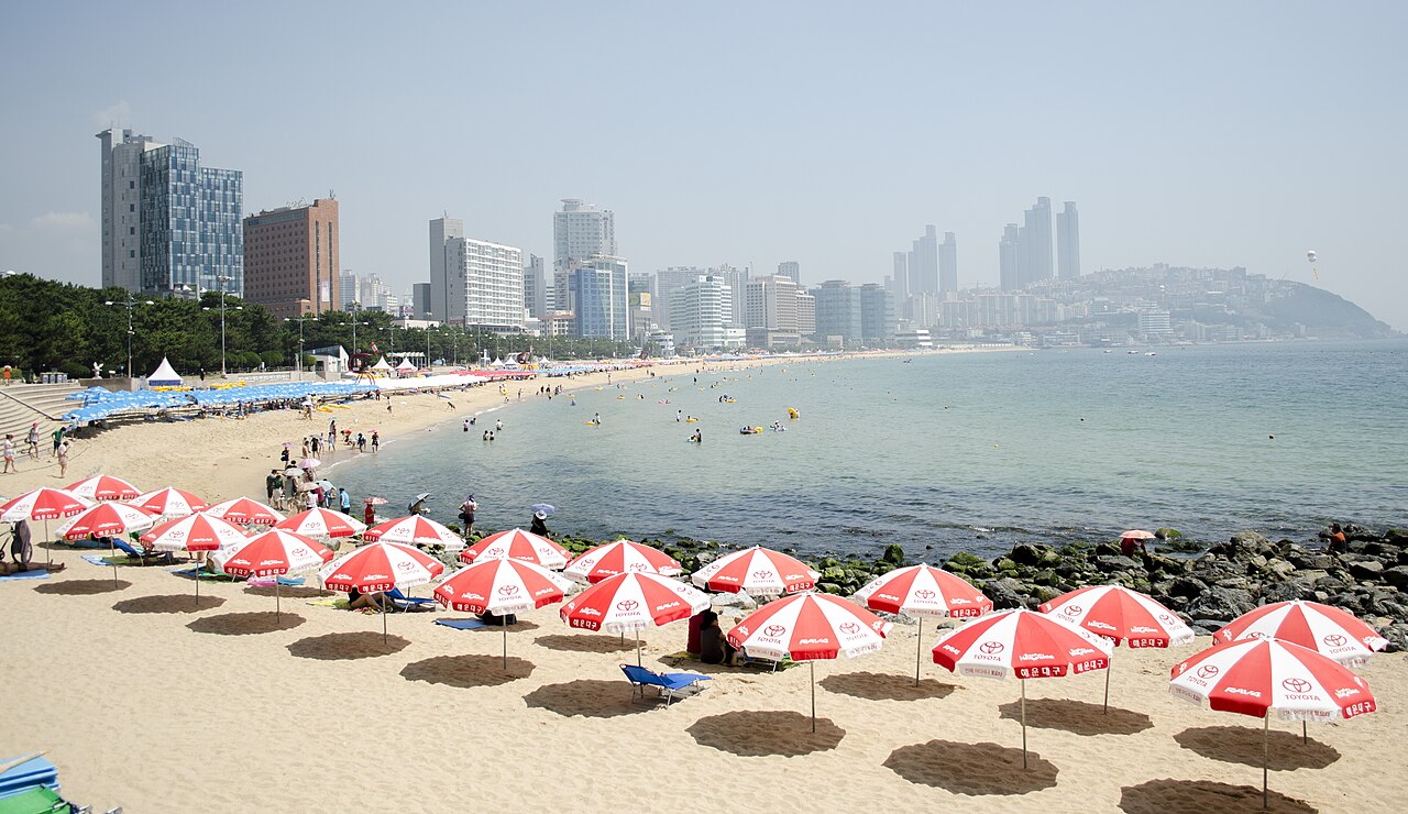 Haeundae Beach in Busan with parasols and the city skyline
