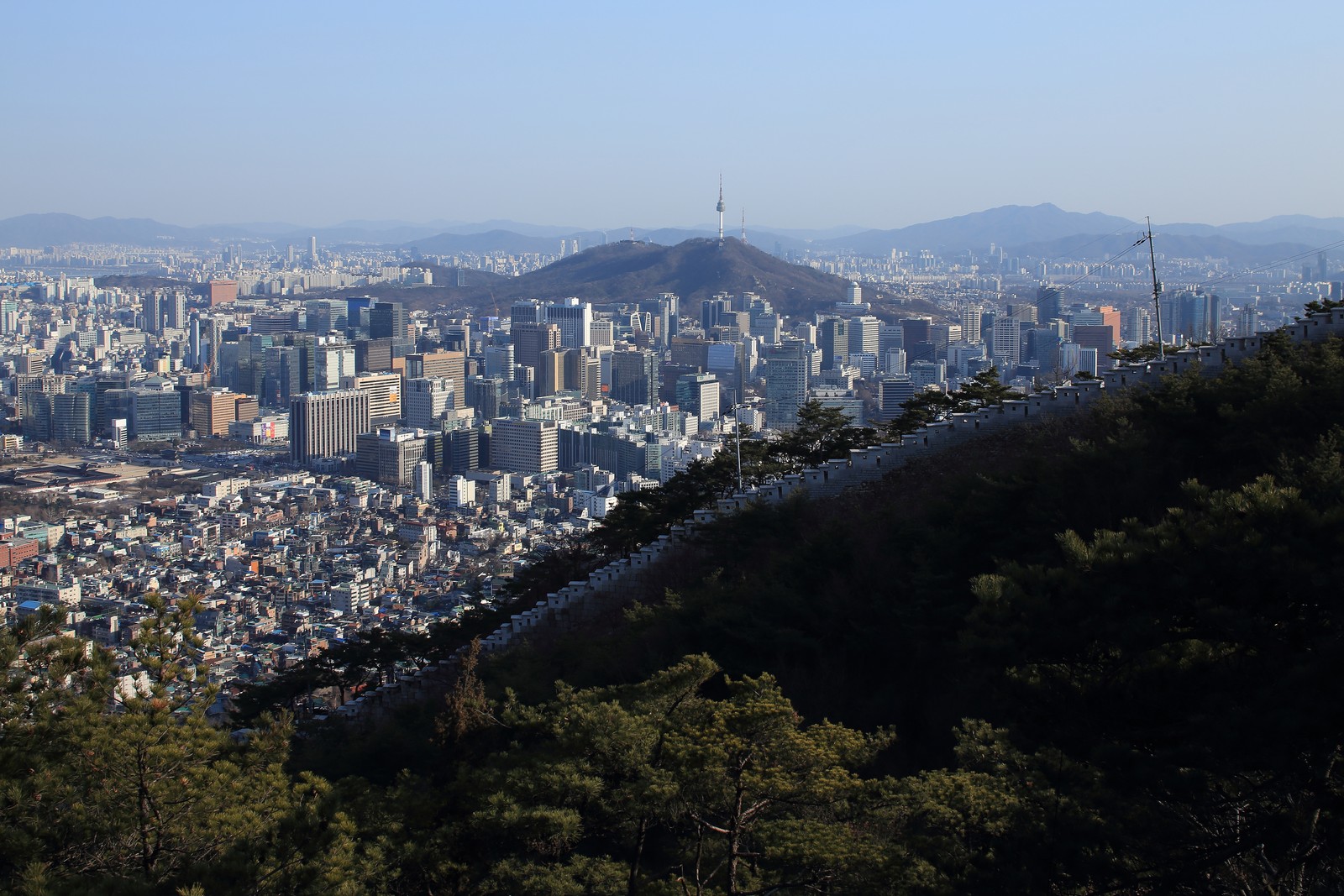 Seoul City Wall and downtown Seoul seen from the mountain ridge for a hiking in Seoul guide