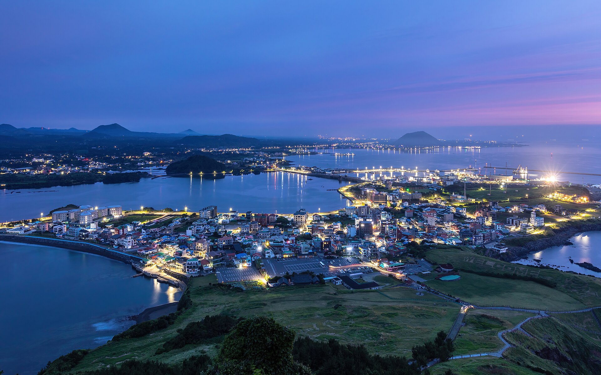 Seongsan-ri town and the sea at blue hour seen from Seongsan Ilchulbong on Jeju