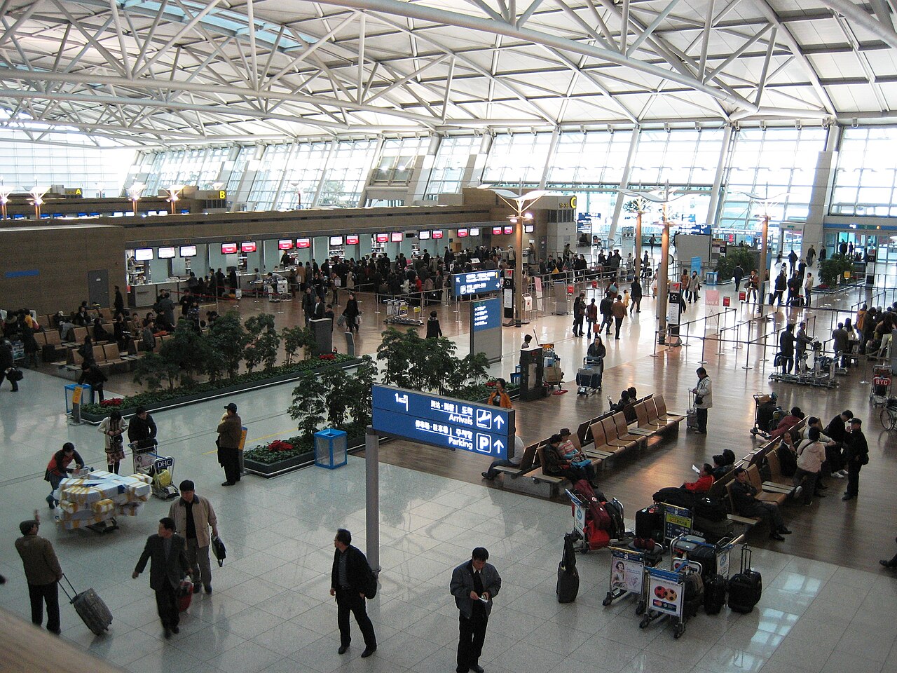 Korea packing list: travellers with suitcases in the Incheon Airport departure hall