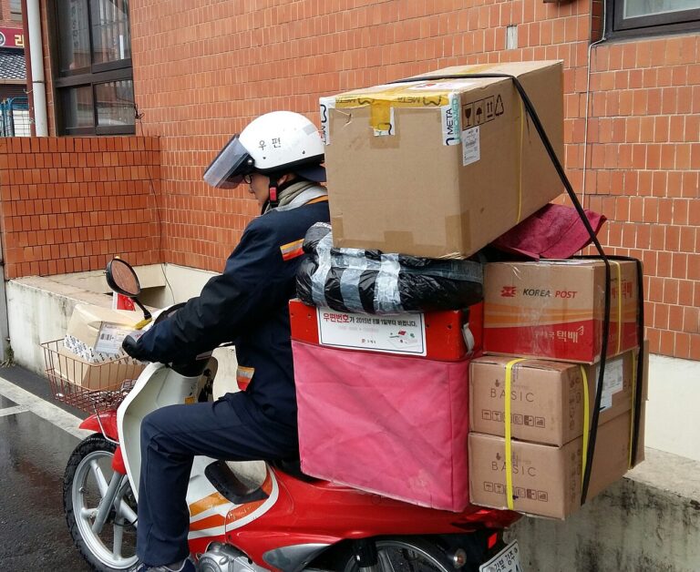 Delivery rider on a motorcycle carrying parcels in Korea