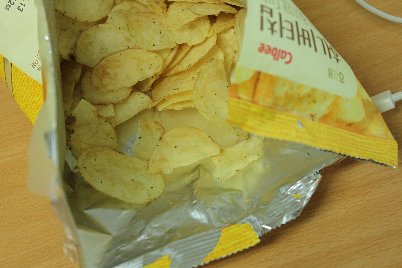 Open bag of Haitai Honey Butter Chip potato chips, a popular Korean snack