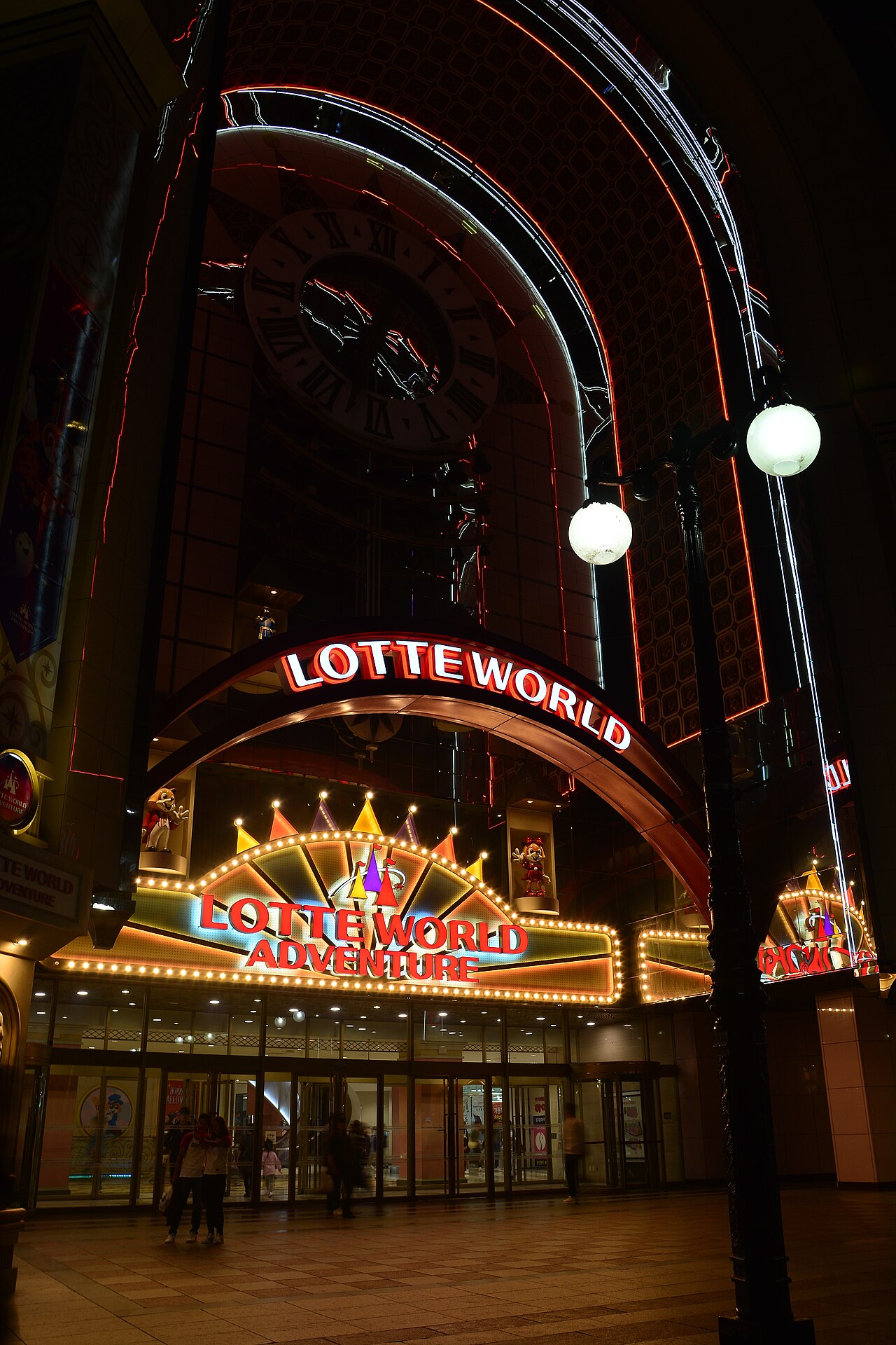 Lotte World Adventure entrance lit up at night in Jamsil, Seoul