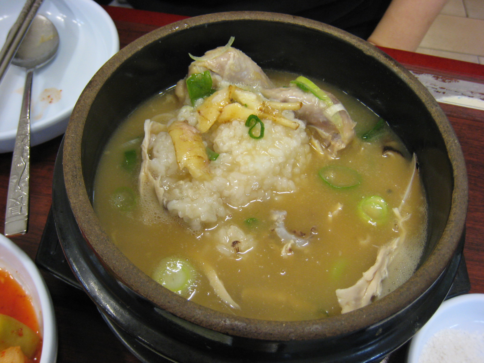 Samgyetang opened up to show the glutinous rice stuffing inside the chicken