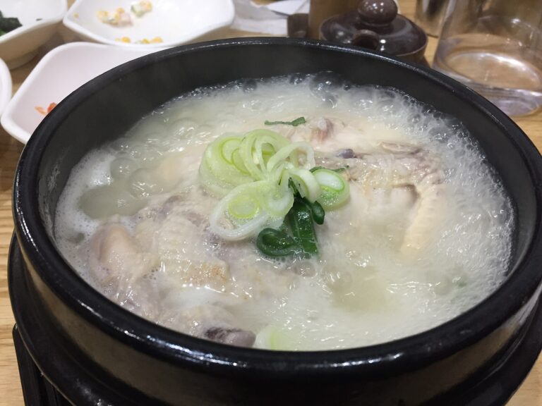 Samgyetang Seoul style: a bubbling earthenware pot of ginseng chicken soup with sliced scallions