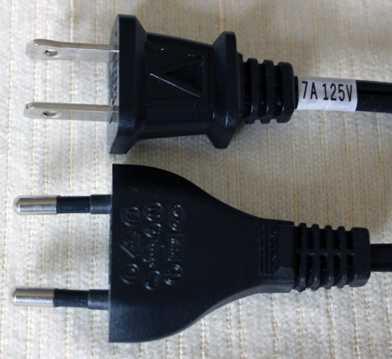 Korea plug type: a two-round-pin Type C plug next to a US Type A plug