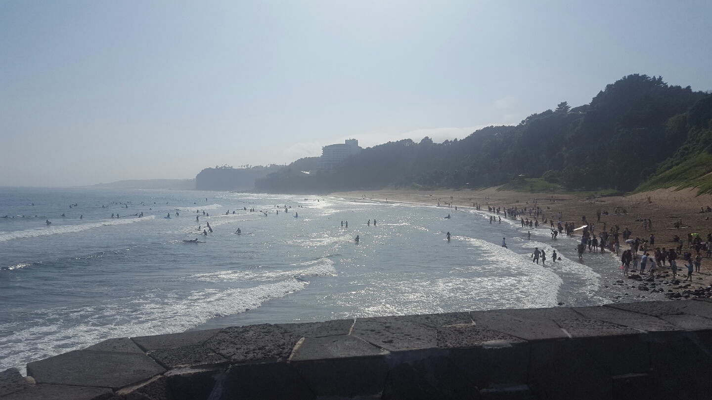 Jungmun Beach with waves and the resort coast on Jeju